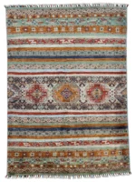 A vibrant Kazak Extra rug featuring intricate tribal patterns in an array of colors, enhancing the room's aesthetic.