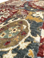 A vibrant Kazak Extra rug featuring intricate tribal patterns in an array of colors.